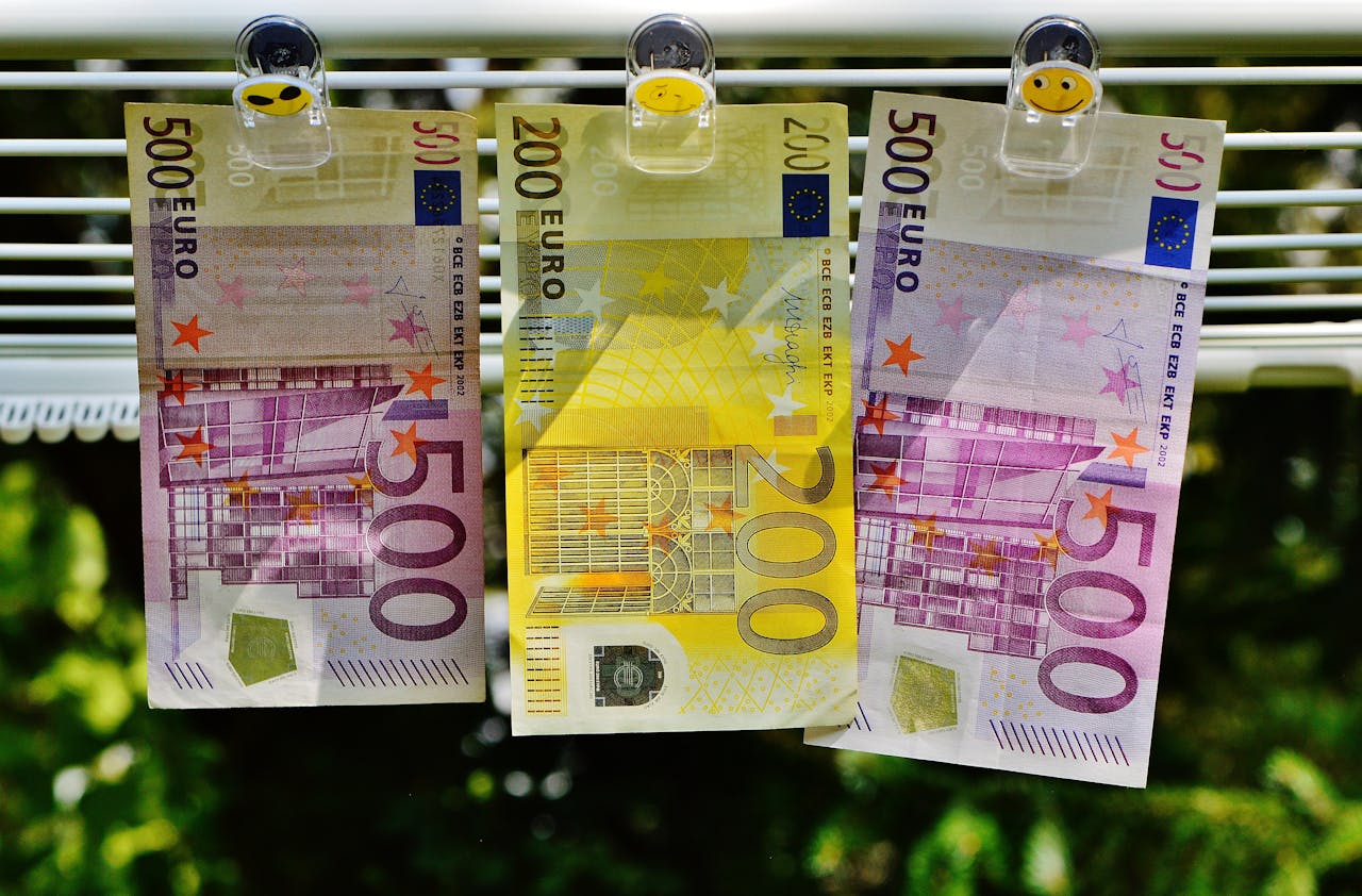 Euro currency notes clipped to a line, symbolizing finance concepts like money laundering or savings.
